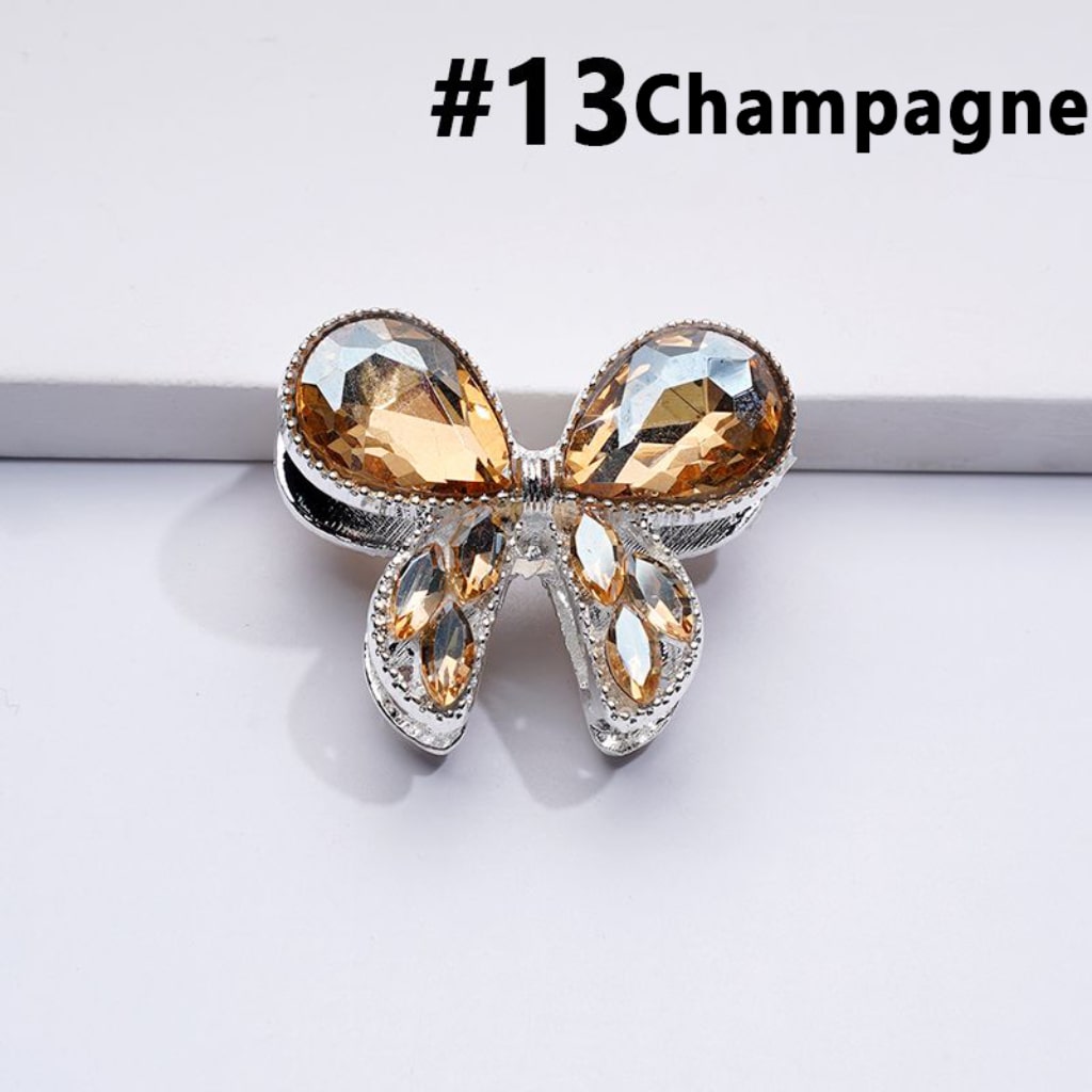 A collection of silver alloy bowknots with colorful shiny rhinestones beads, in various colors.