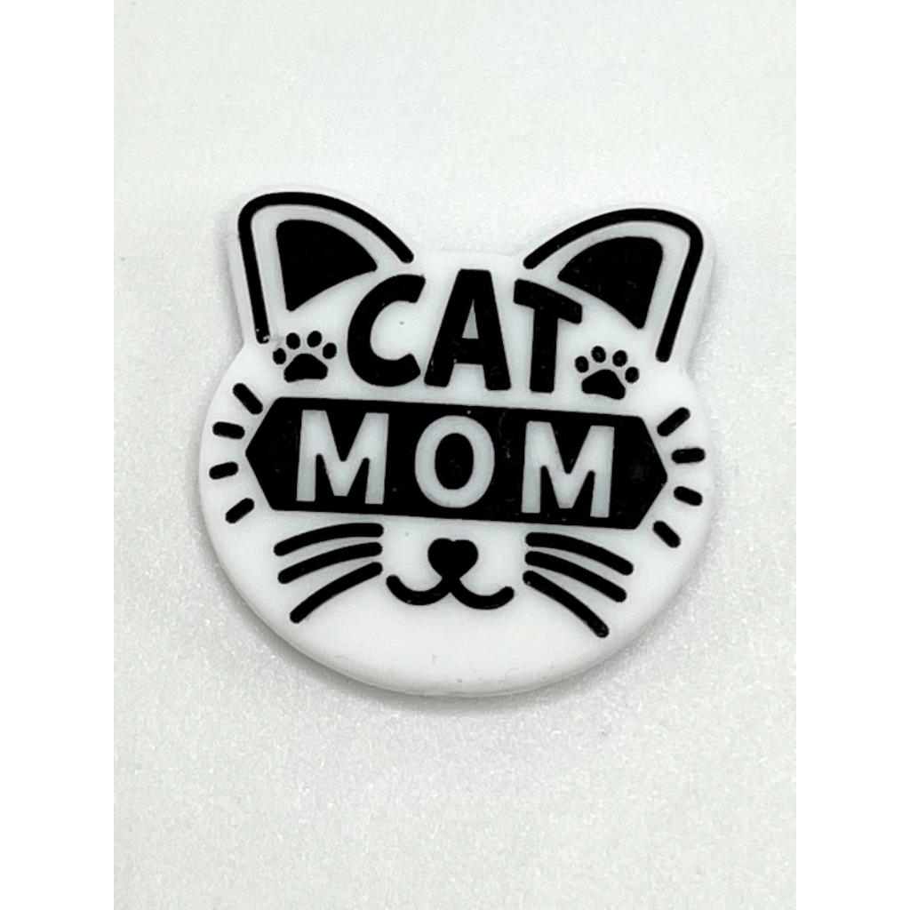 A silicone bead in the shape of a cat's face with the text 'CAT MOM' across the center.