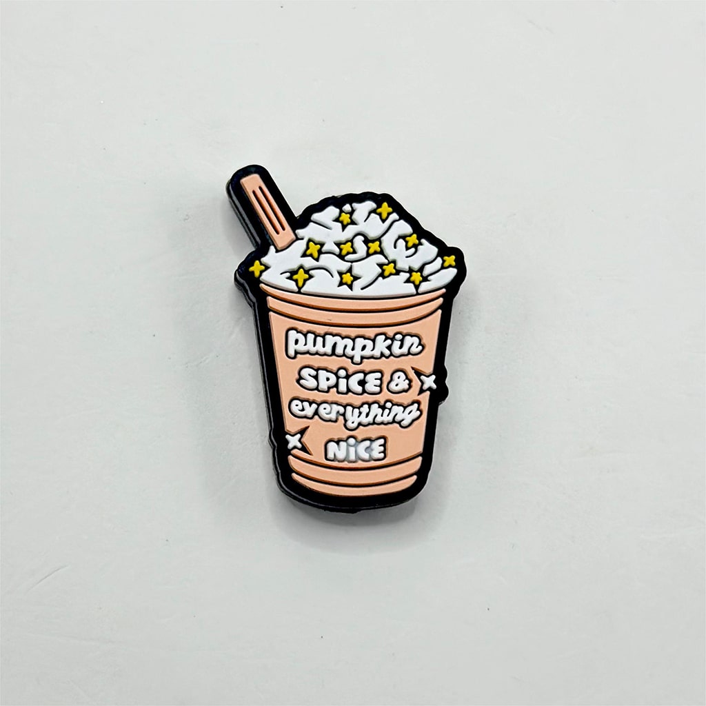 A silicone bead with a design resembling a cup of pumpkin spice ice cream with the text 'Pumpkin Spice & Everything Nice' on it.