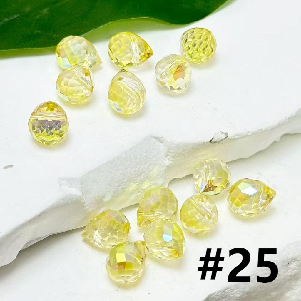 Yellow gemstones on a white surface with a leaf