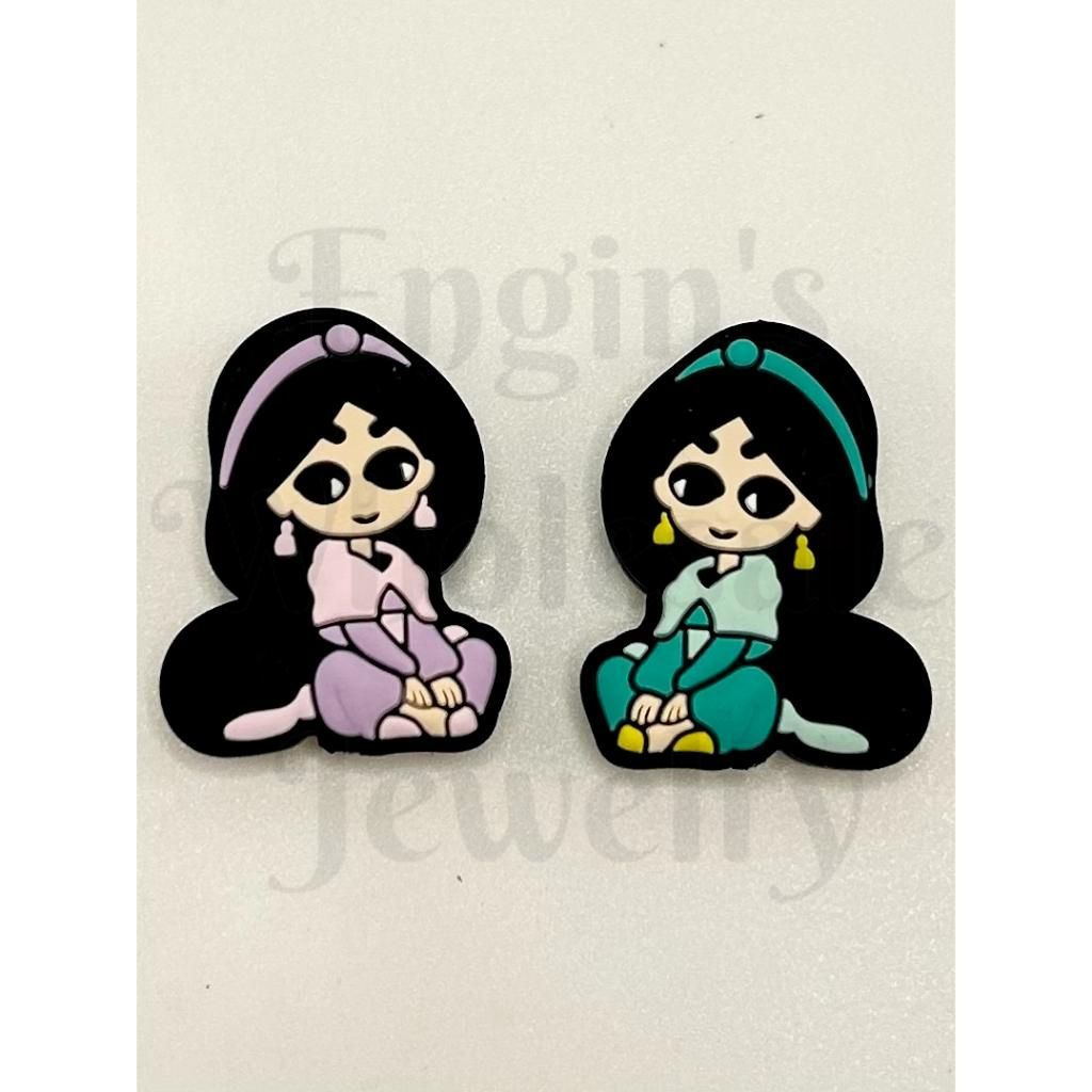 Two cartoon character pins on a beige background