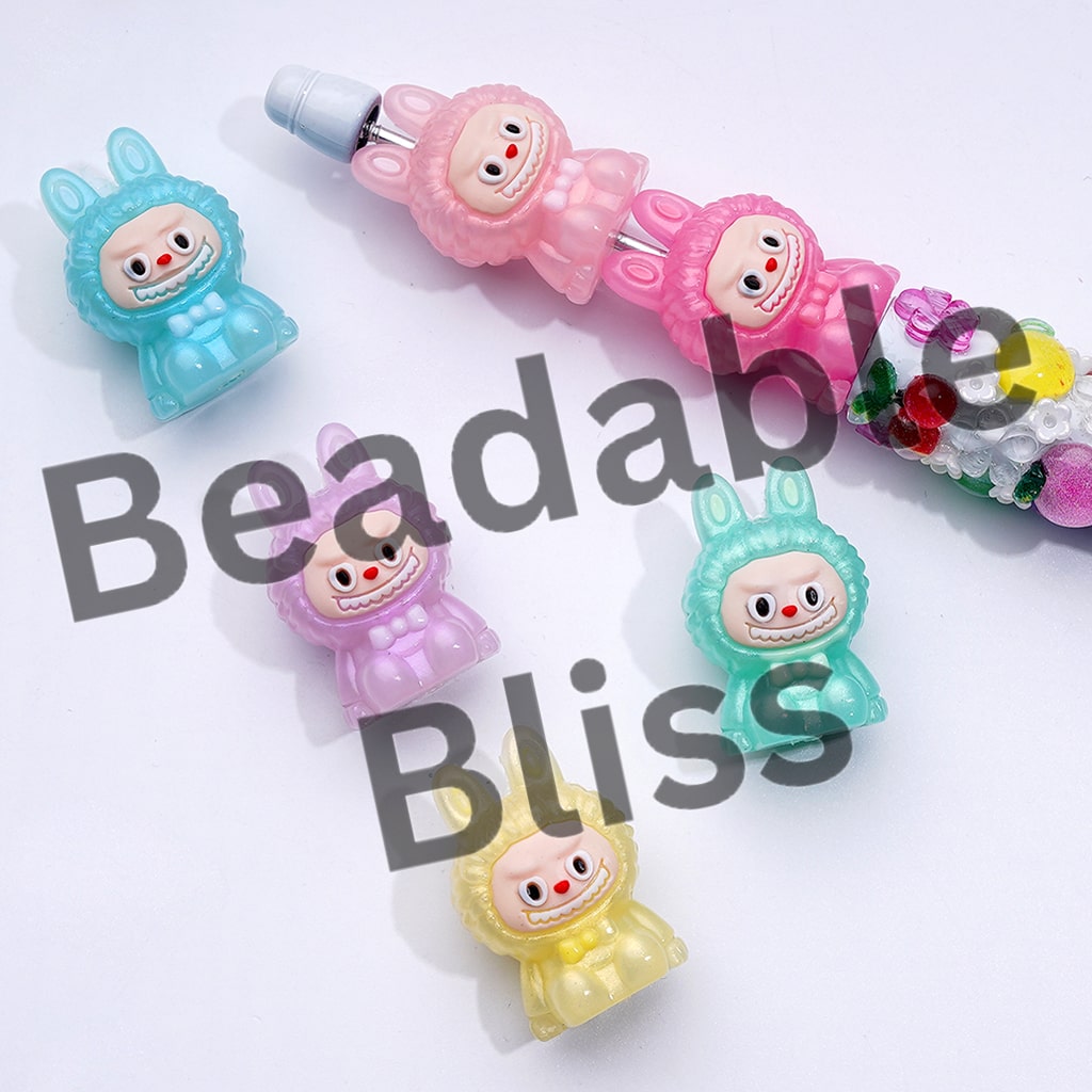 Colorful cartoon character beads with 'Beadable Bliss' text on a white background