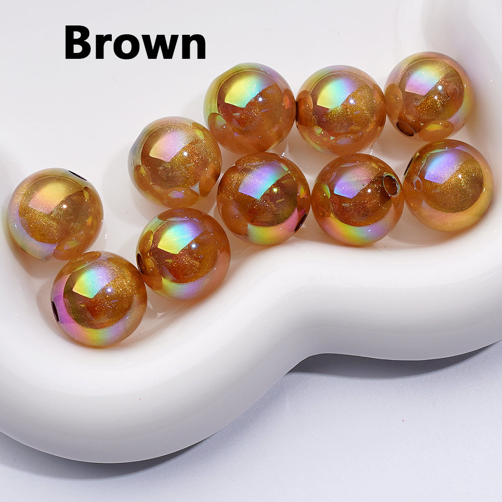 Brown glass beads with iridescent sheen on a white surface