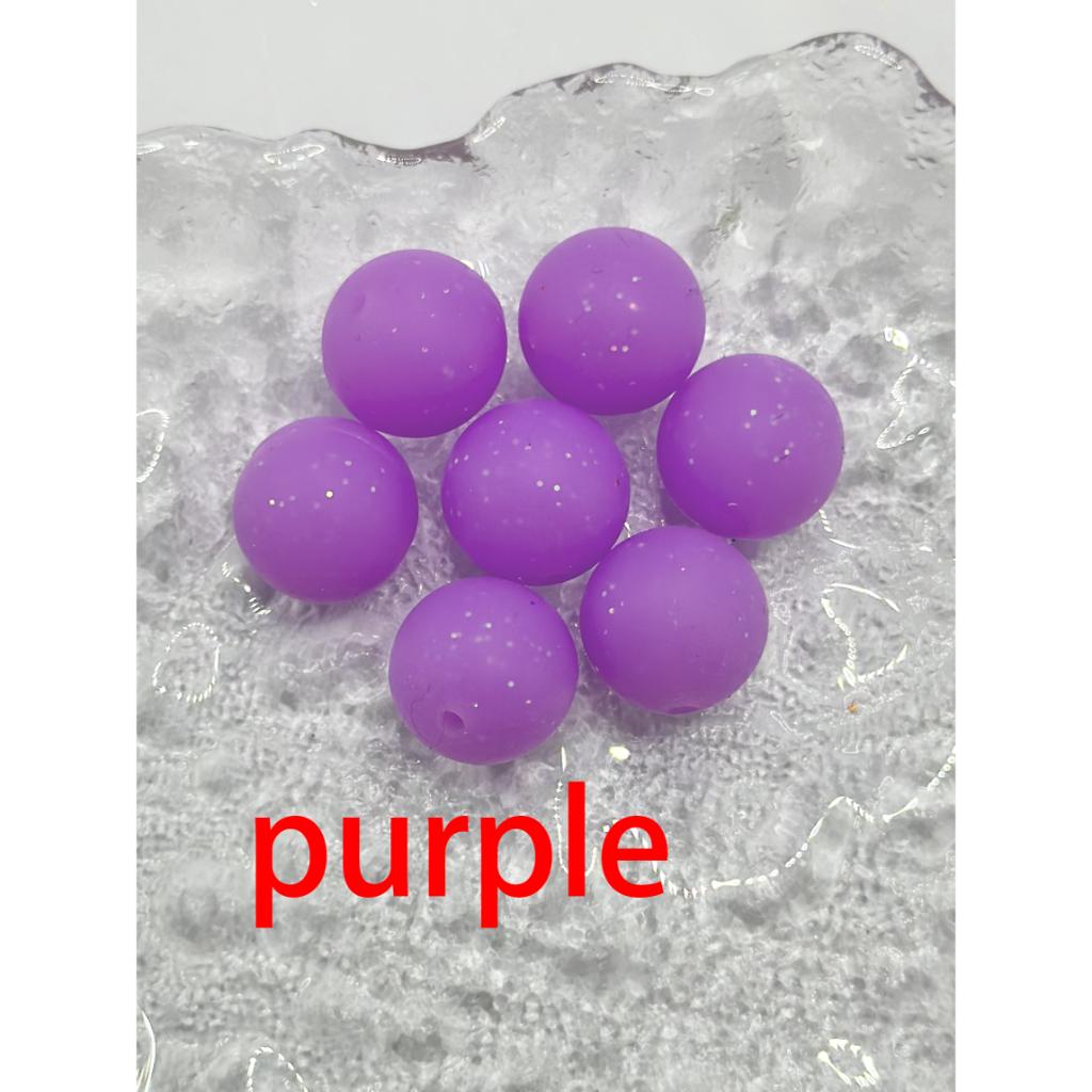 Purple beads on a textured gray surface with 'purple' text.
