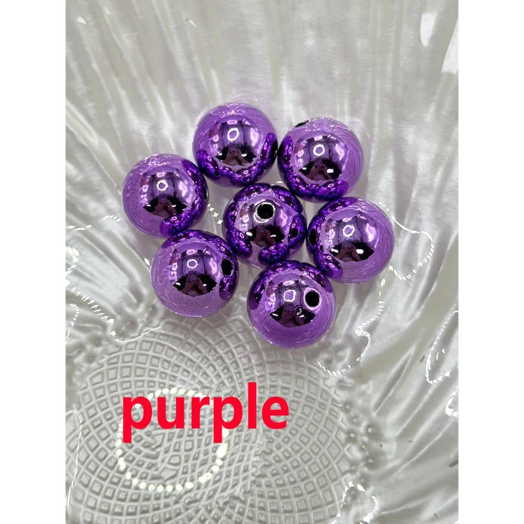 Purple beads on a textured white surface with 'purple' text.