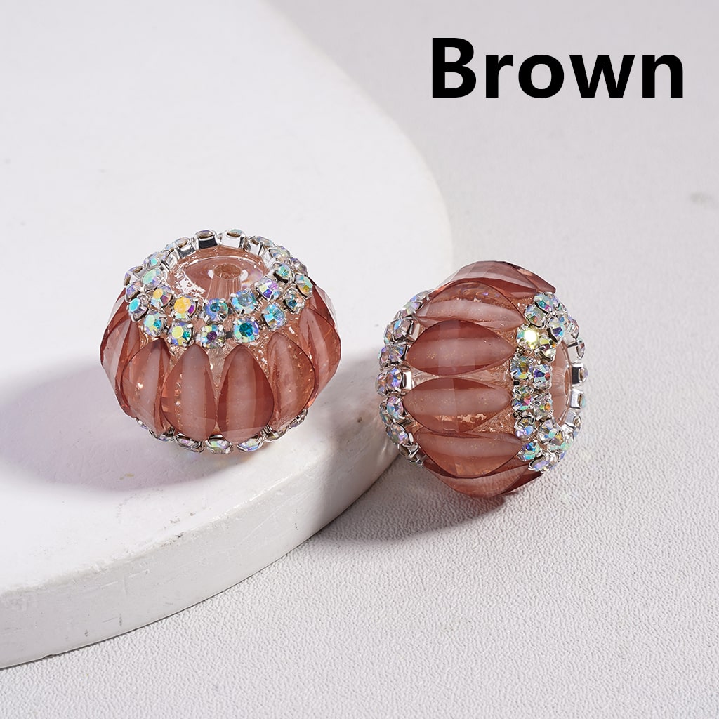 Decorative ring with brown central stone and multicolored gemstones on a white background