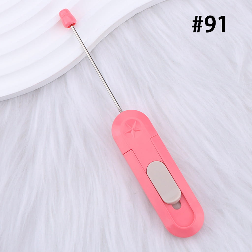 Pink handheld milk frother with a white background
