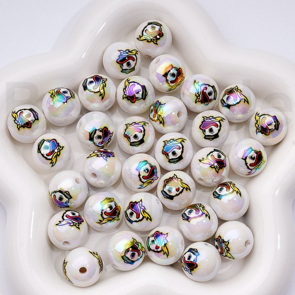 White beads with colorful fish designs on a white surface