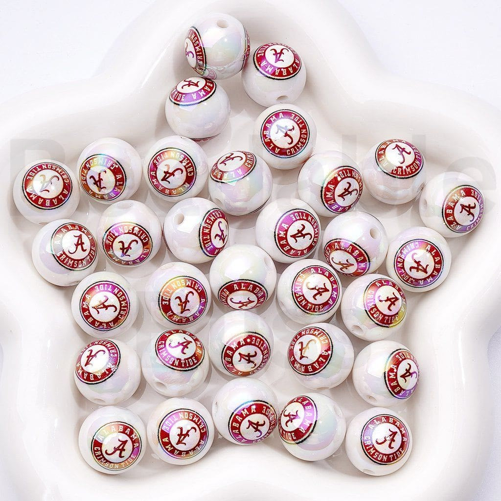 White beads with red and pink logos arranged on a white surface