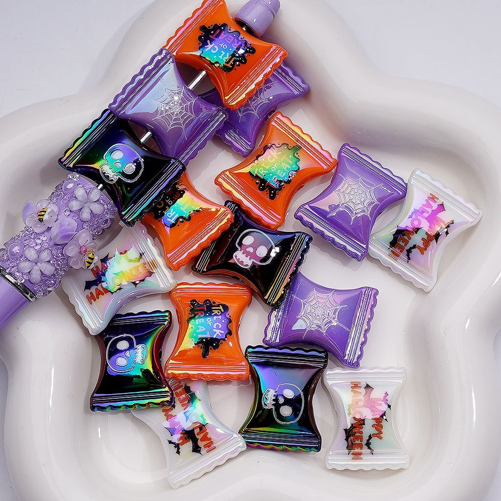 Colorful nail polish bottles with Halloween-themed designs on a white surface