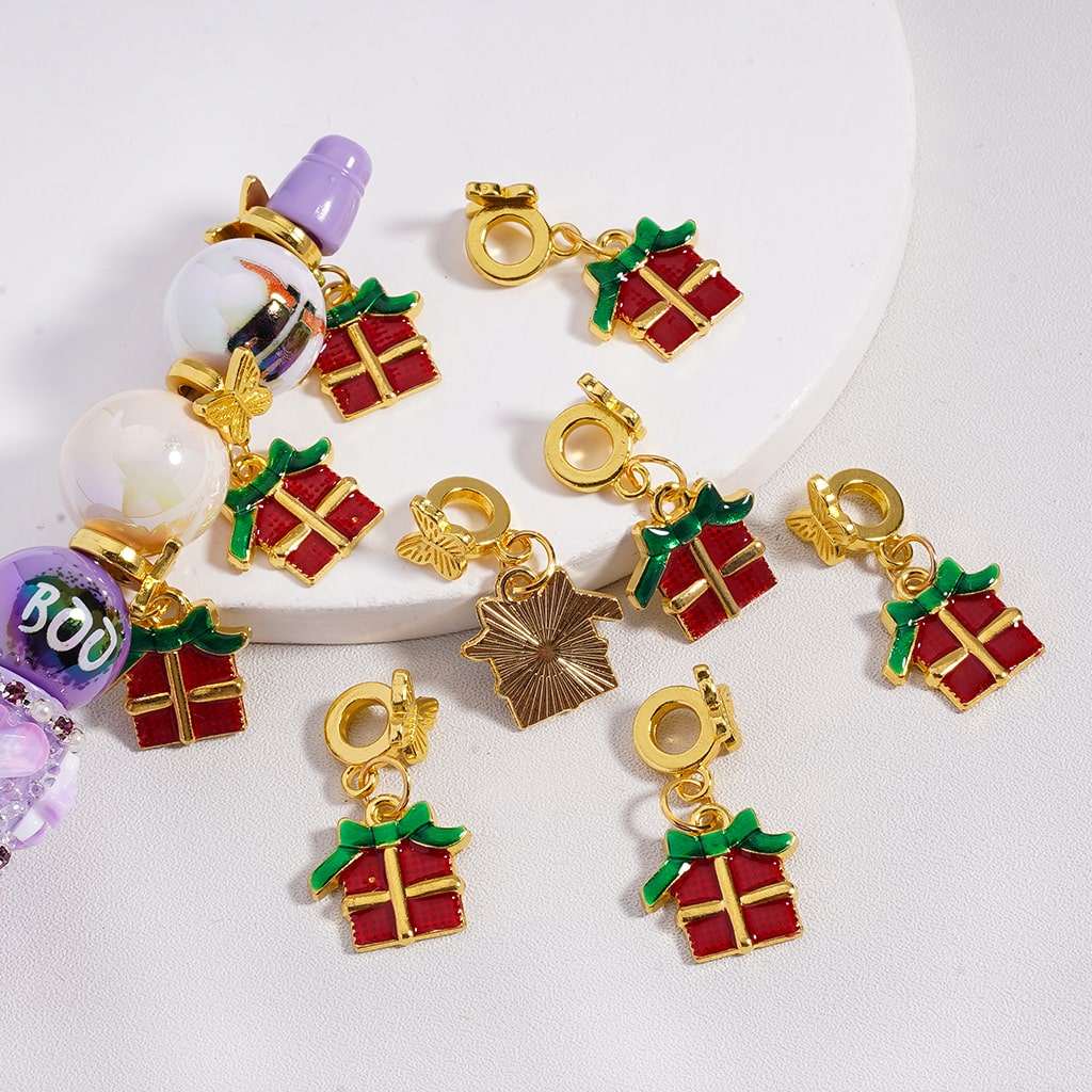 Gold and red gift box charms on a white background