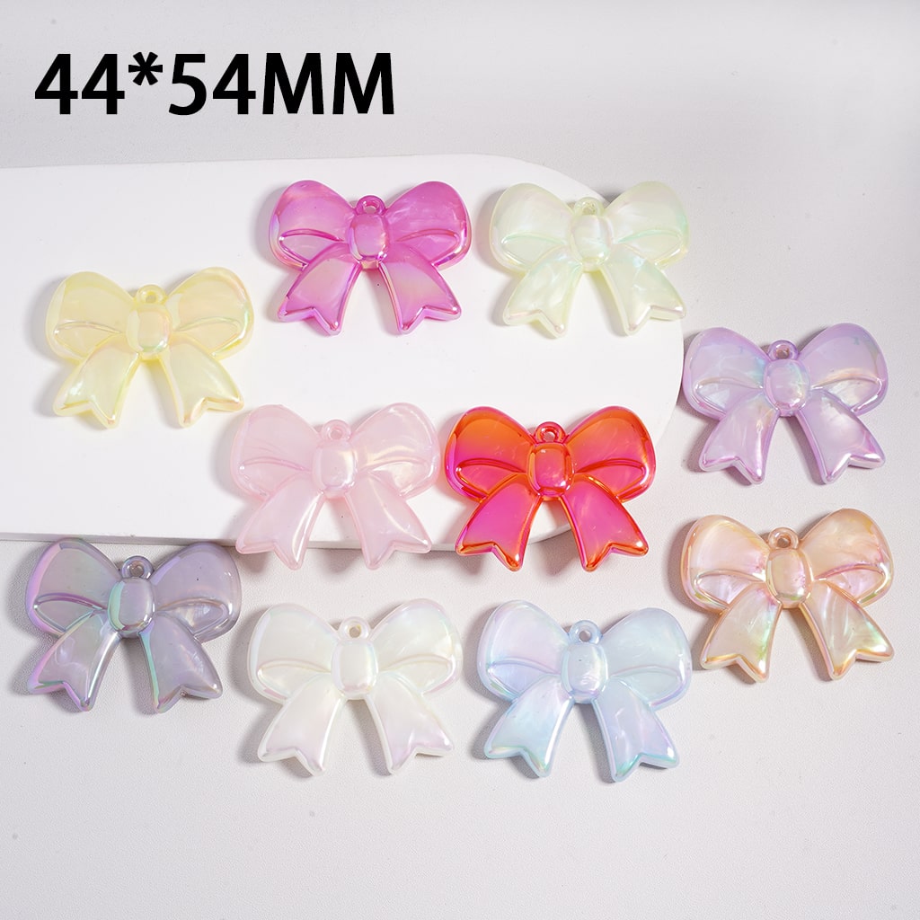 Iridescent bow-shaped objects on a white background with dimensions 44*54MM.