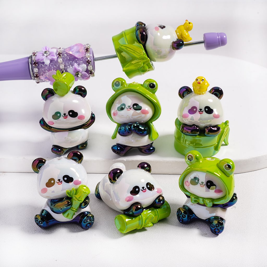 Set of panda-themed figurines with green and purple accents on a white background
