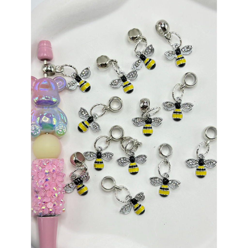 A collection of clear rhinestone charms shaped like bees, with alloy chains and decorative settings, displayed on a white surface.