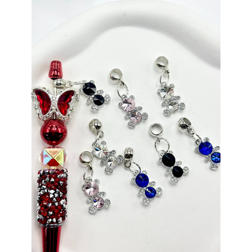 A collection of alloy charm chains with little bear rhinestones attached to them, displayed on a white surface.