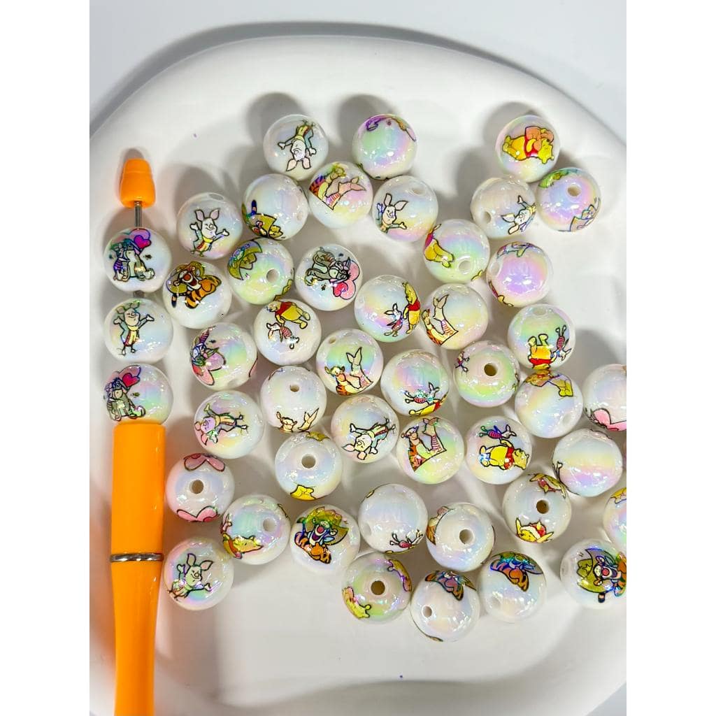 Set of round beads with cartoon characters on a white plate