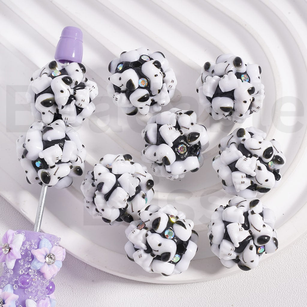 Panda-shaped earrings on a white plate with a light purple background