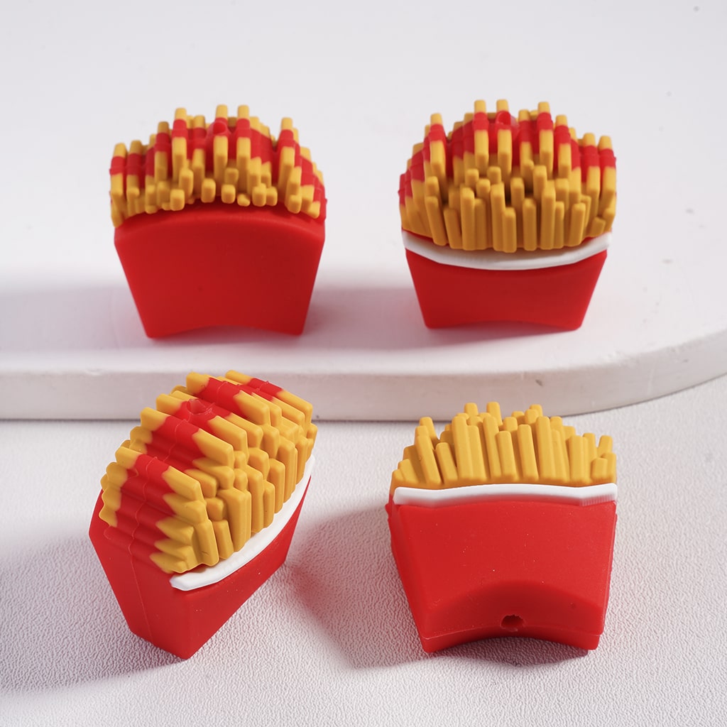 Four red containers with yellow French fries on a white background