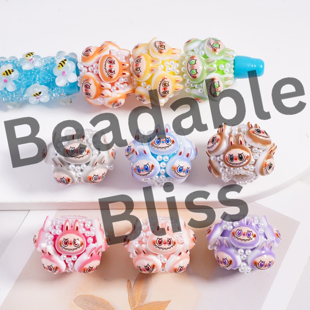 Colorful beaded toys with 'Beadable Bliss' text on a white background