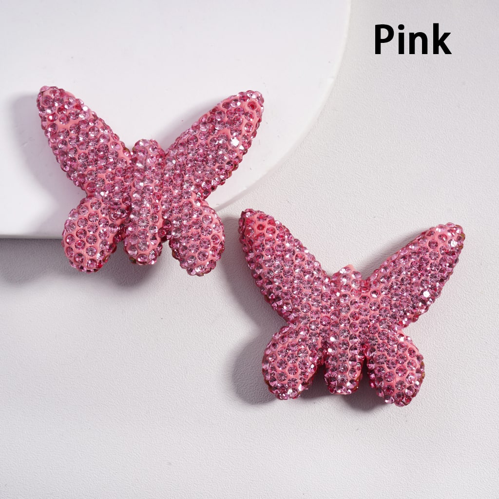 Pink butterfly-shaped earrings on a light gray background