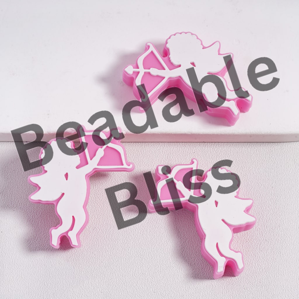 Pink and white silicone letter-shaped molds on a light gray background