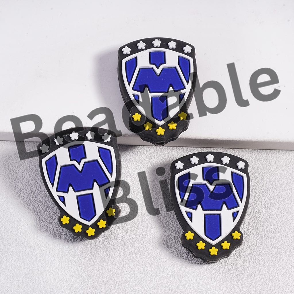 Silicone Focal Beads Shield Shape with Blue "M" and Flowers in White & Yellow Colors