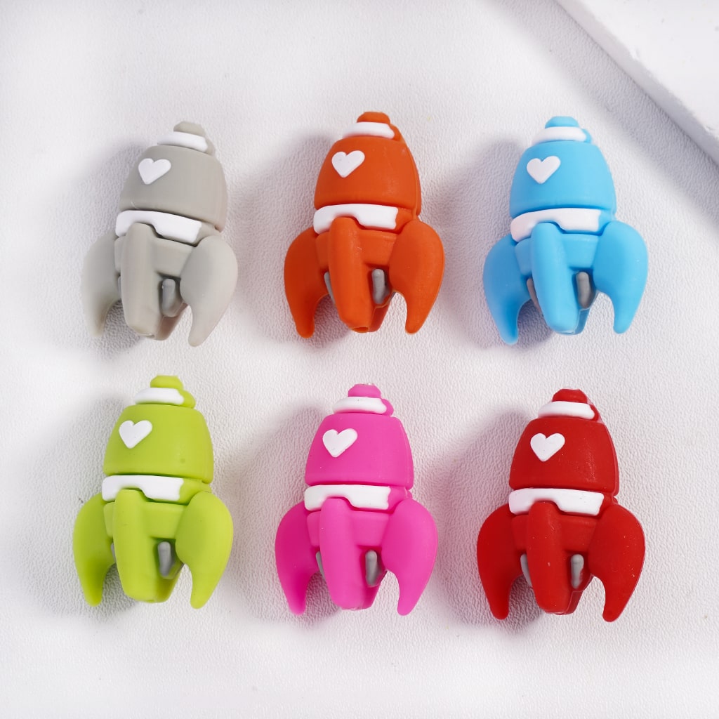 Set of six colorful rocket-shaped clips on a white background