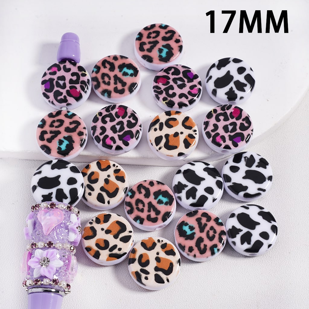 Set of 17MM leopard print beads with a purple tool on a white background