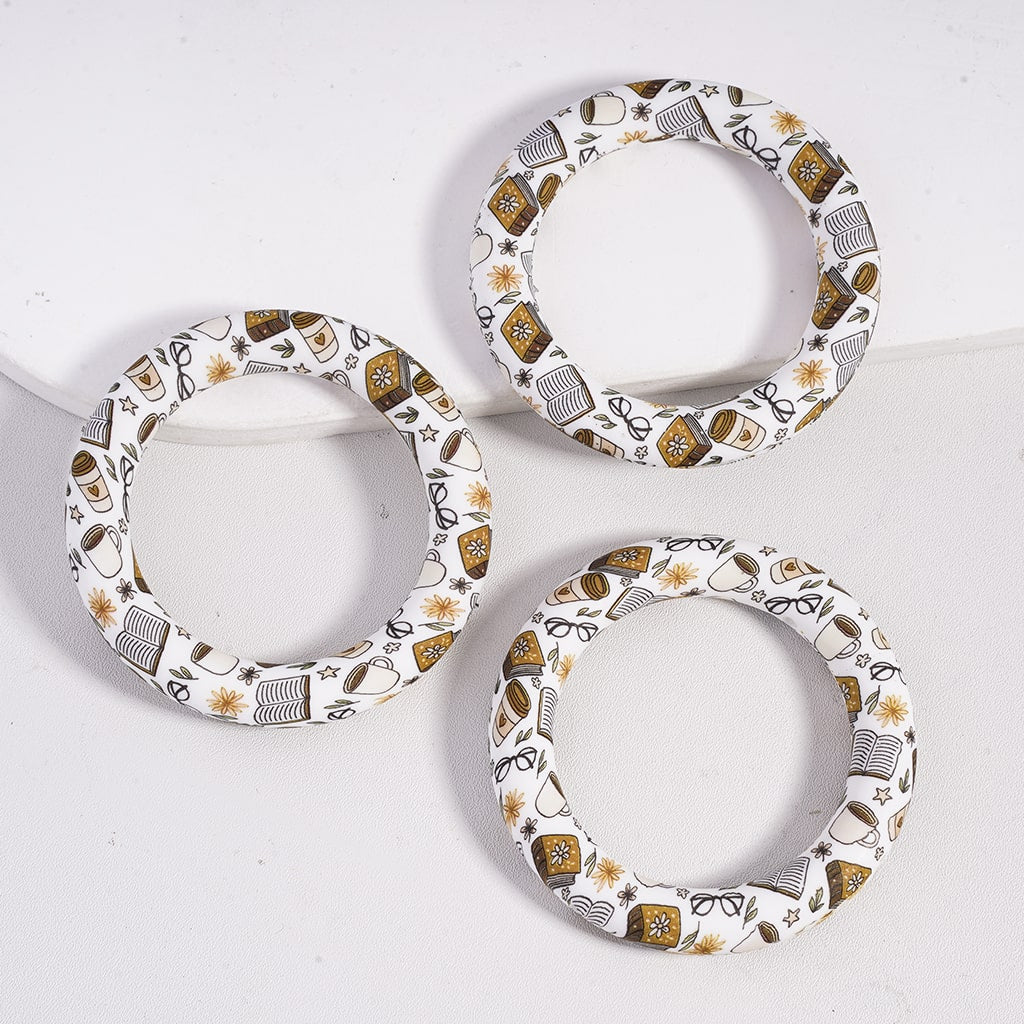 Three decorative rings with intricate patterns on a white background