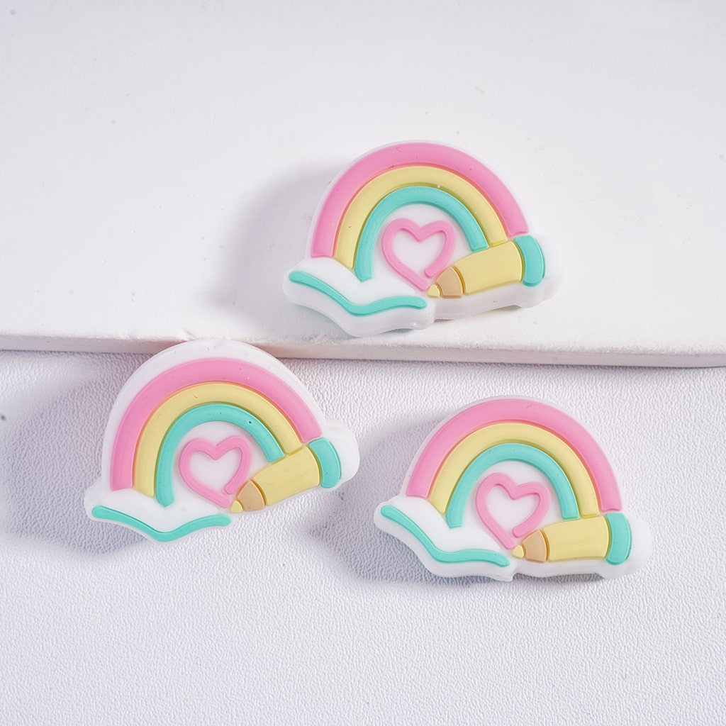 Three colorful rainbow-shaped objects with hearts on a white background