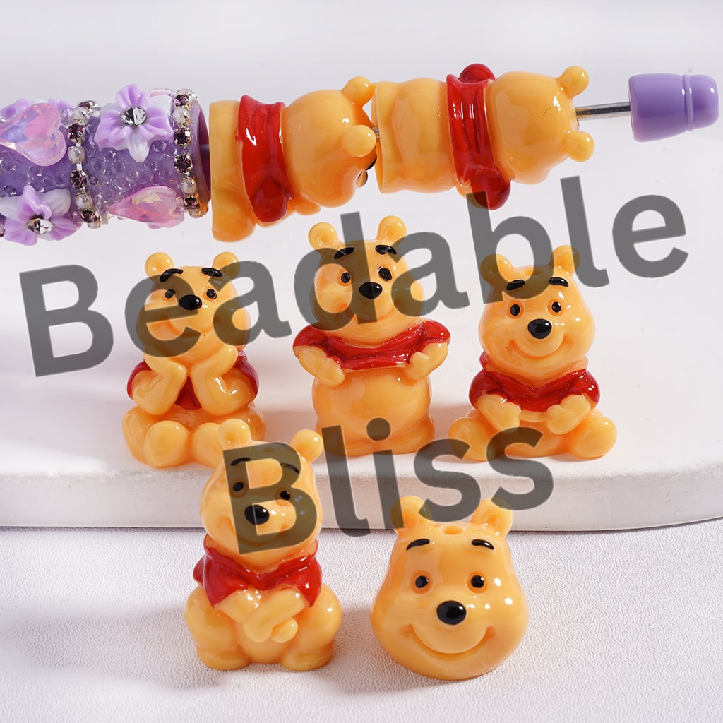 Set of Winnie the Pooh-themed beads and charms on a white background with 'beadablebliss' branding.