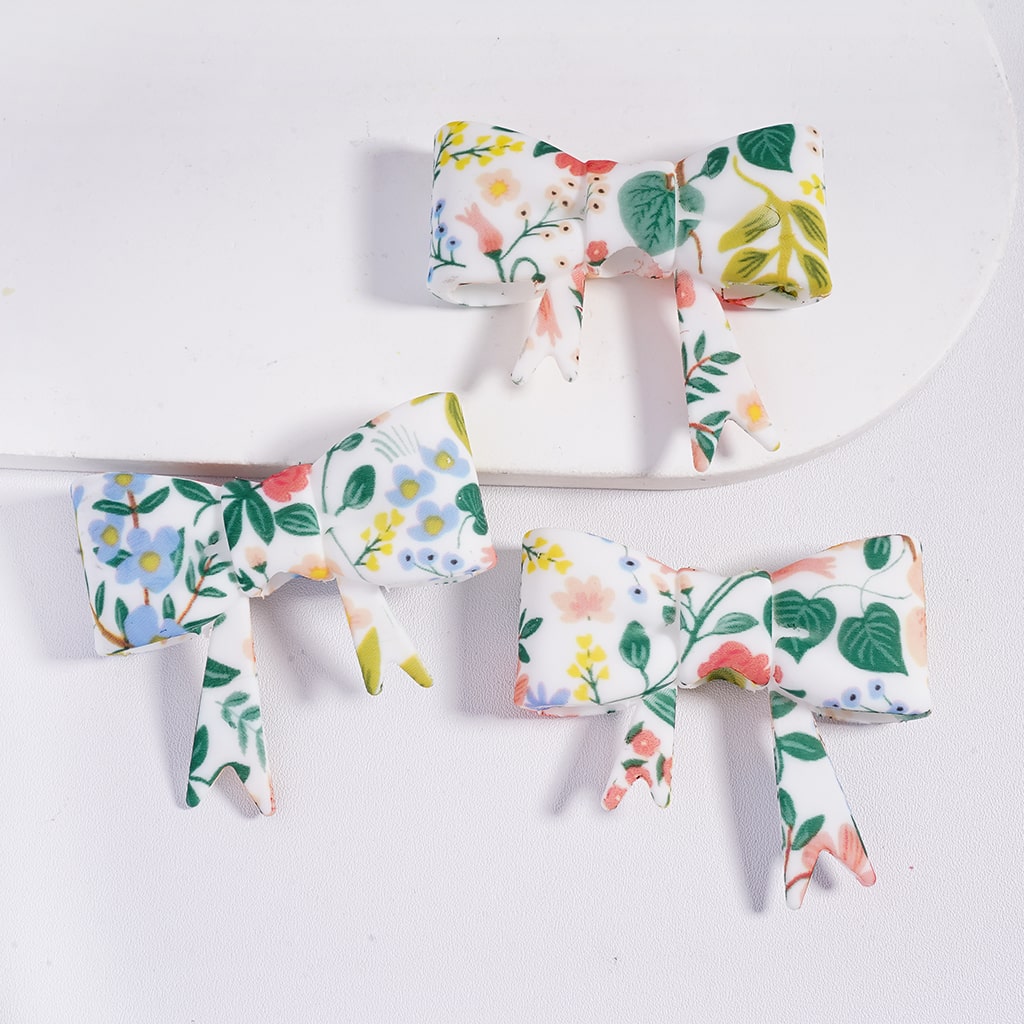 Set of floral-patterned hair bows on a white background