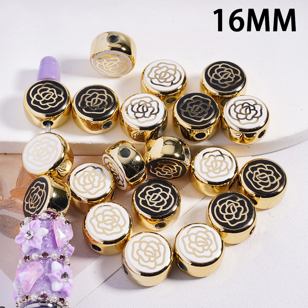 Gold, black, and white beaded jewelry with a purple bead on a white background