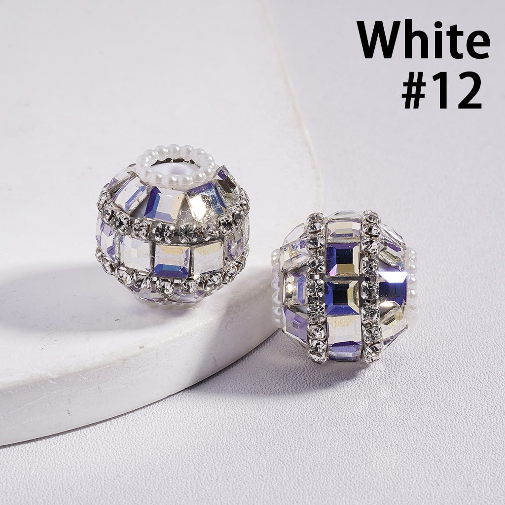 Pair of silver and purple gemstone earrings on a white surface with 'White #12' text.