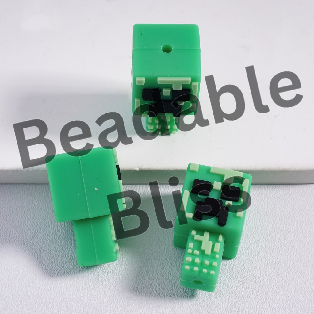 Green pixelated character figurines on a white background with 'beadablebliss' text.