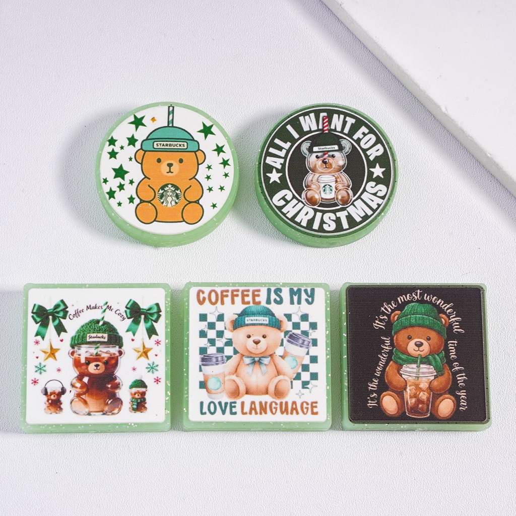 Set of bear-themed coasters with Starbucks branding on a white surface