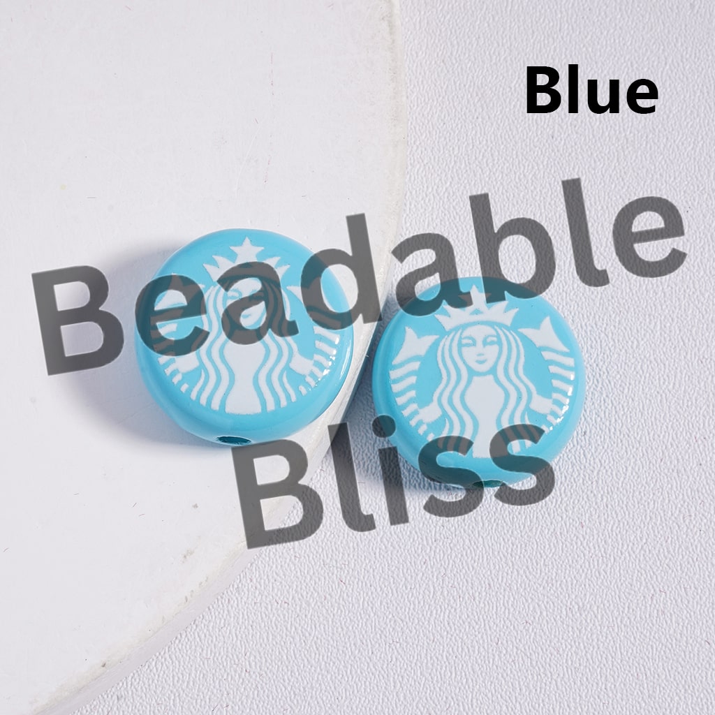 Round turquoise Starbucks logo button on a white fabric background