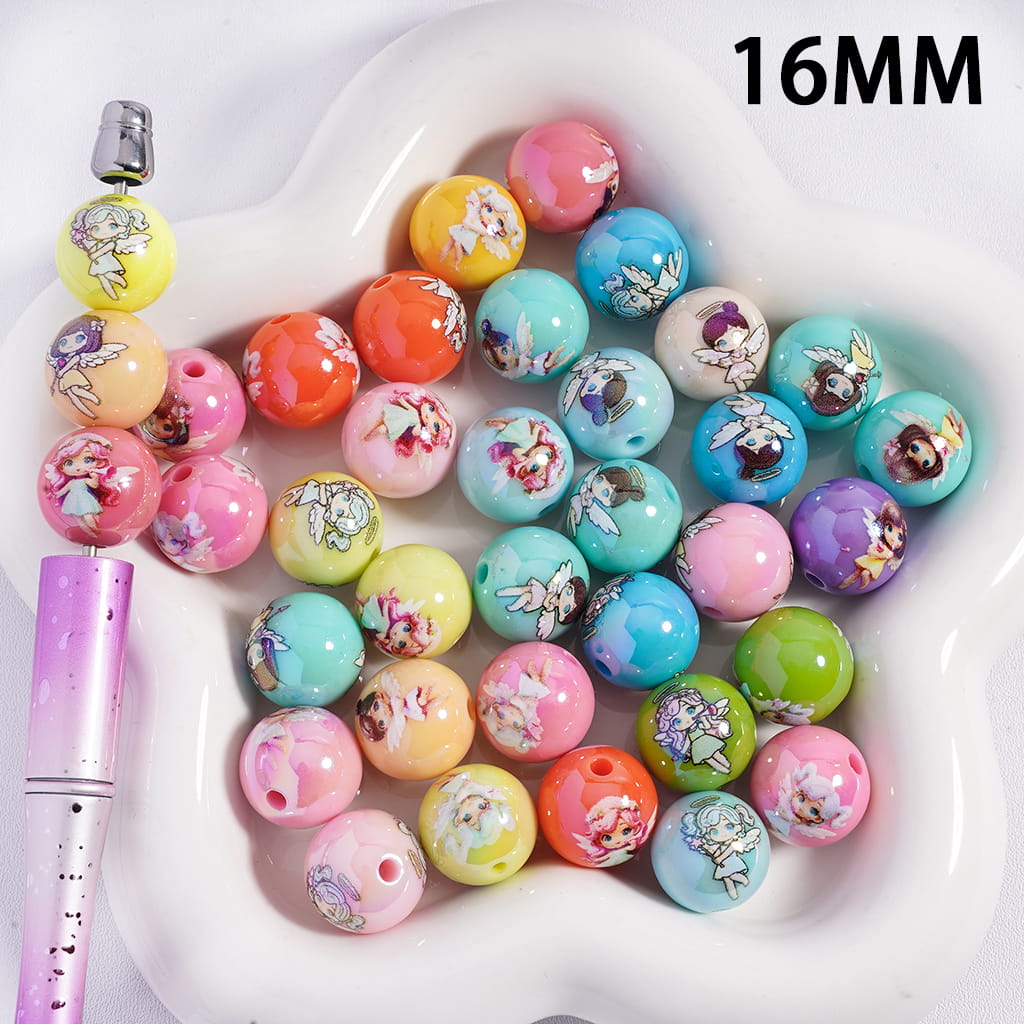 Colorful bubblegum beads with cartoon characters on a white dish, with a pen for scale.