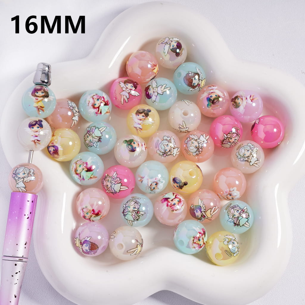 Colorful beads with floral designs on a heart-shaped white dish, with a pen for scale.