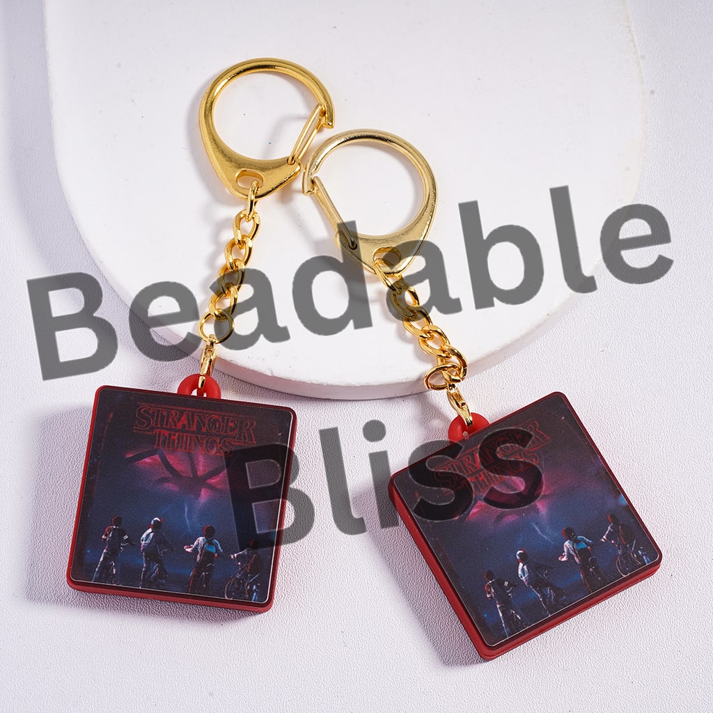 Keychain with 'Stranger Things' design on a white background, featuring the brand 'hansonsupply.com'.