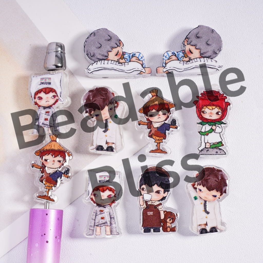 Set of cartoon character bookmarks and a pen on a white background