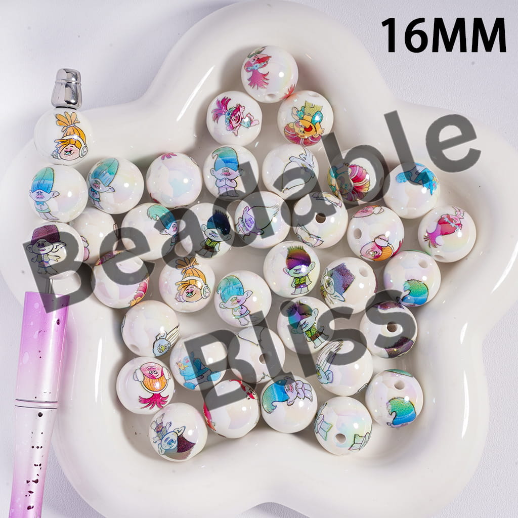 Colorful cartoon-themed beads on a white plate with a pen.
