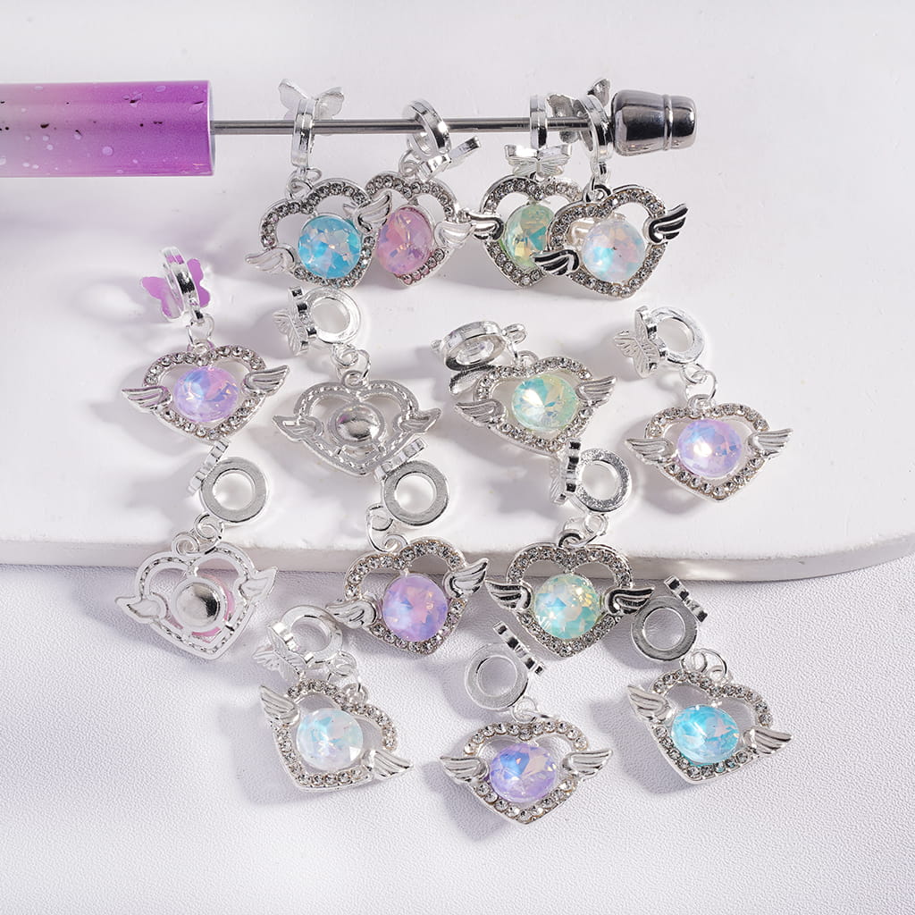 Set of decorative charms with gemstones on a white background