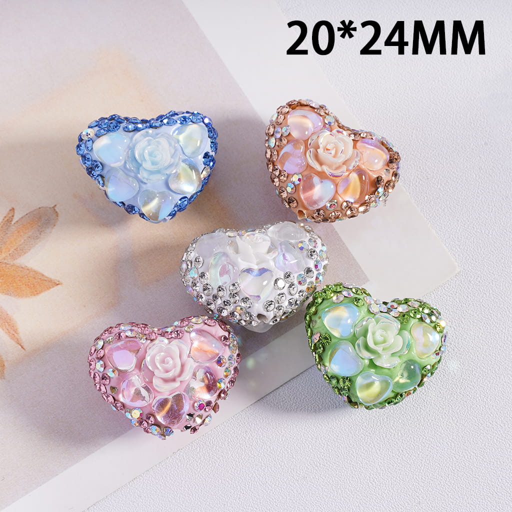 Heart-shaped decorative stones with floral designs on a light background