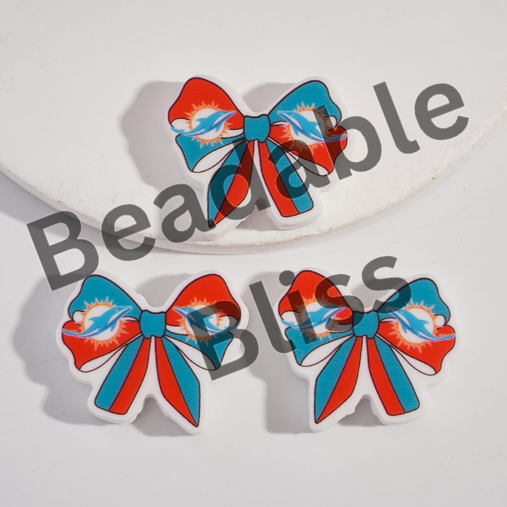 Bow-shaped earrings with red and blue design on a white background, branded 'handsontosupply'.