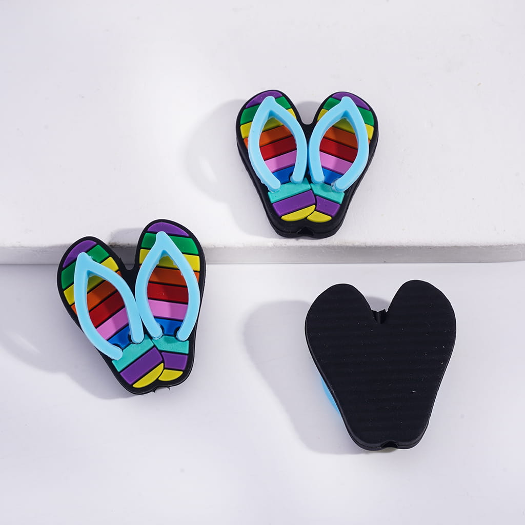 Colorful flip-flop-shaped clips on a white background