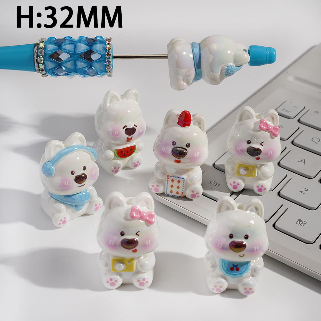 Set of small bear figurines with accessories on a laptop keyboard