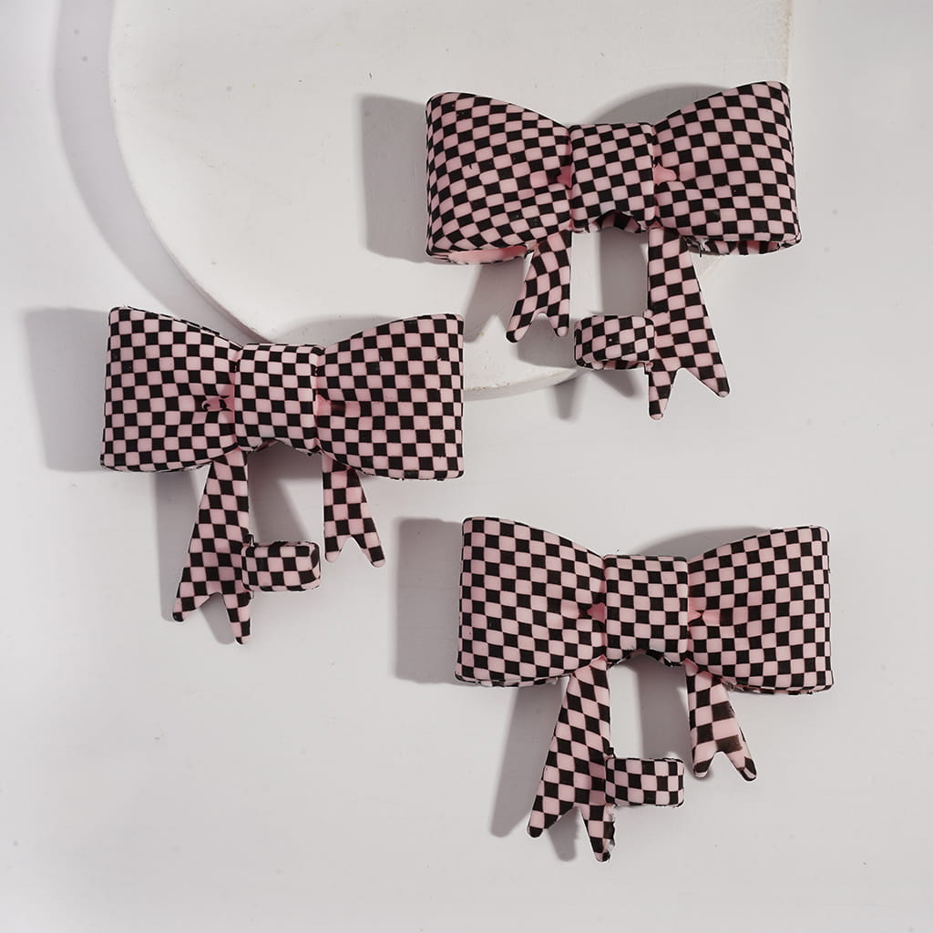 Three checkered bows on a light gray background
