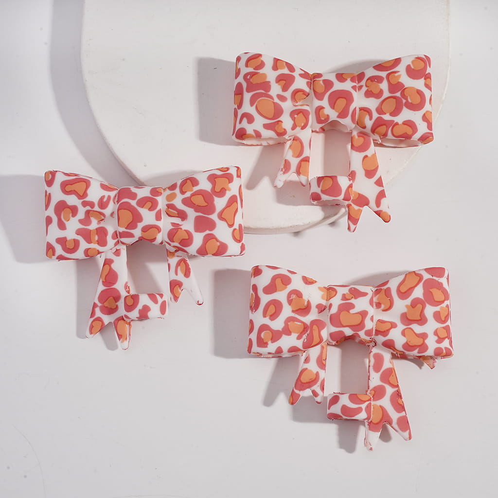 Four decorative bows with a red and white pattern on a white background