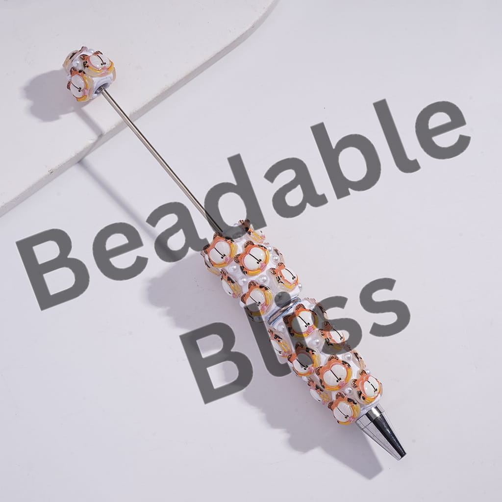 Decorative pen with bead embellishments on a light background with 'Beadable Bliss' text.
